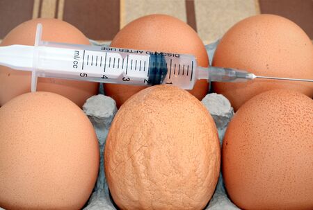 Eggs one of which looks strange and probably is unhealthyの写真素材