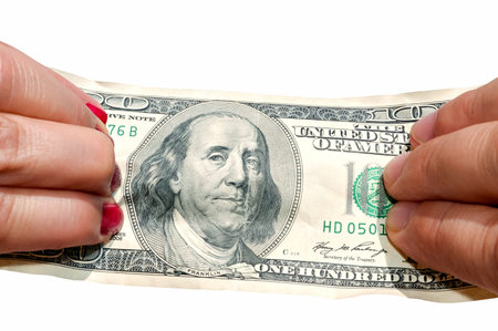 Two hands stretching banknote isolated on white background