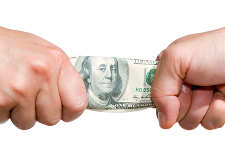 Two hands stretching banknote isolated on white backgroundの写真素材