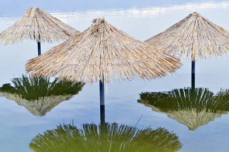 Reed sunshades flooded after havy rains connected with climate changesの写真素材