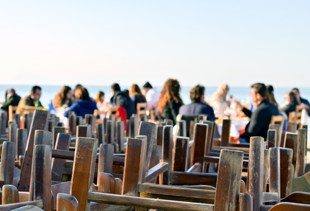 People in a restaurant by the sea are resting and enjoying in the sunny dayの写真素材