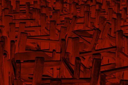 Monochrome image of bunch of chairs turned upside down for backgroundの写真素材