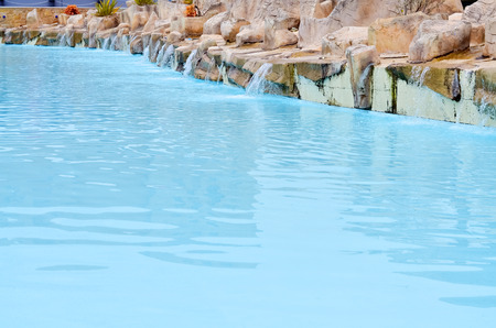 Beautiful swimming pool with turquoise water in front of the hotelの写真素材