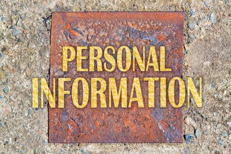 Text Personal Information written in golden letters on a rusty iron panelの写真素材