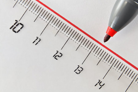 Closeup of a drawn straight red line and nib of a felt pen