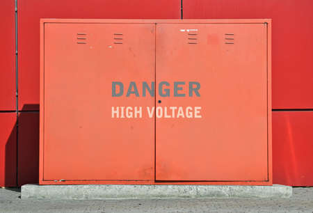 Text High Voltage written on a red street transformerの写真素材
