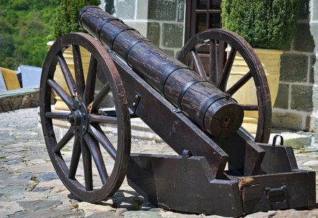 Closeup of an old medieval wooden cannon as a cultural heritage