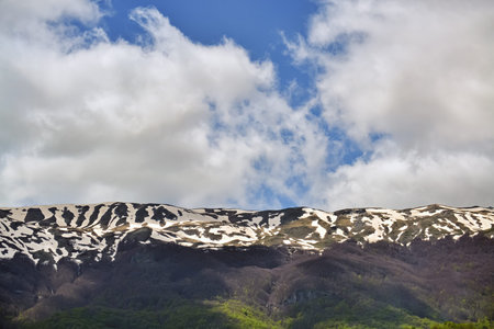 Part of a mountain with melting snow during the springtime
