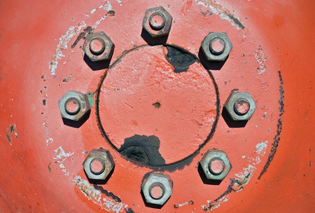 Closeup of eight tighten screws symmetrically arranged in a circleの写真素材