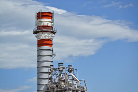 Detail of a factory with pipeline and tall chimney
