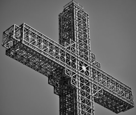 Closeup of the steel construction of a christian cross in black and white colorsの写真素材