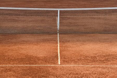 Part of a clay tennis court and the netの写真素材
