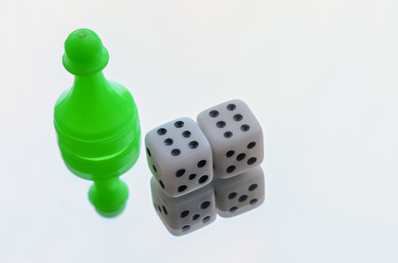 Pair of dices and a pawn on bright backgroundの写真素材