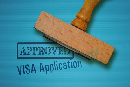 Text Visa Application and rubber stamp on blue backgroundの写真素材