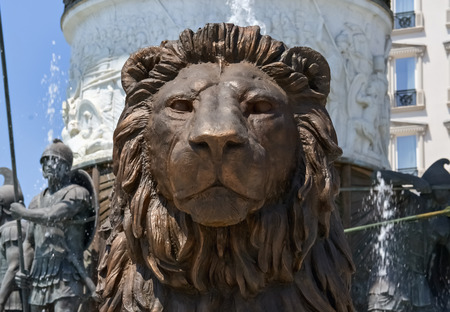 Bronze face of a lion and water fountain under the monument of Alexander the Greatの写真素材