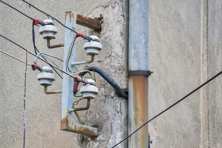 Closeup of old wires and risky power supply with obsolete equipmentの写真素材