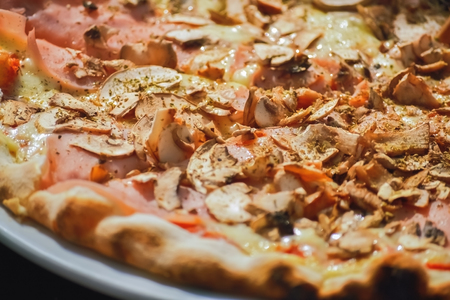 Closeup of a baked pizza made by traditional recipeの写真素材