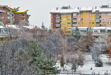 Idyllic view to the small city park in a beautiful snowy dayの写真素材