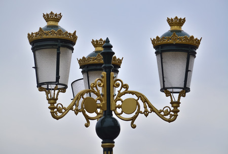 Closeup of a decorative street lamp with the sky in the backgroundの写真素材