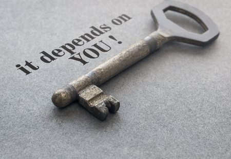 Text It Depends on You and a key on gray backgroundの写真素材