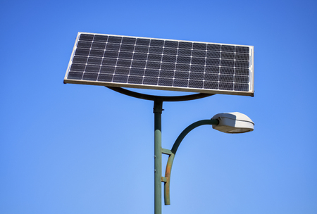 Solar panel and street lamp with clear blue sky in the backgroundの写真素材