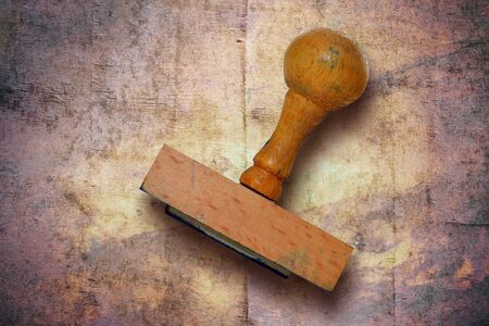 Closeup of an old wooden stamp on vintage backgroundの写真素材