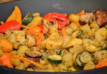 Closeup of baked and seasoned potatoes in a casseroleの写真素材