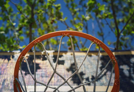 Detail of a basketball hoop on the playground viewed from belowの写真素材