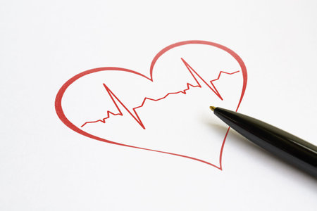Red heart with stylized cardiogram and a pen on bright background
