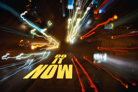 Text Do It Now on a dark abstract backgroundの写真素材