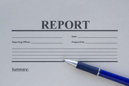 Blank report form printed on paper and a penの写真素材
