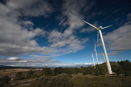 windmills under clouds sky