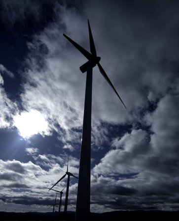 windmills under clouds sky