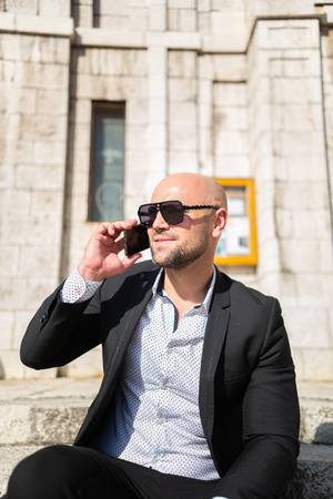 A handsome young businessman talking on his phoneの写真素材