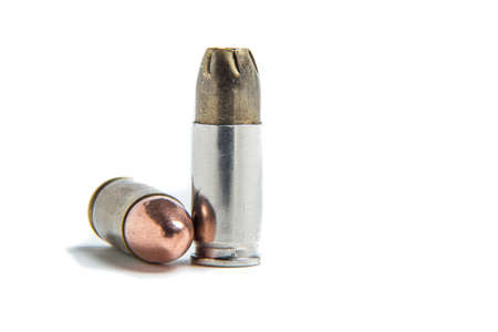 9mm jacketed hollow point cartridge compared to a 9mm full metal jacket 9x19 parabellum.の写真素材