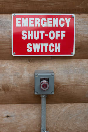 Emeregency shut-off button and sign near a hazardous machine.の写真素材