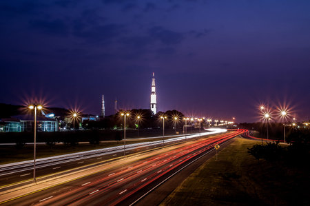 Interstate Traffic blurs by the Saturn 5 rocket on dispalay at the Space and Rocket Center