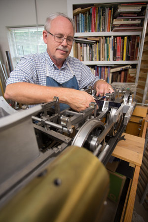 Happy Retired Man working on a large model in his workshop.