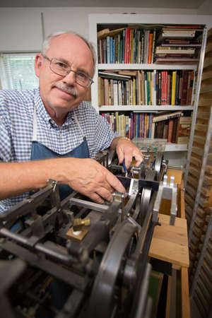 Happy Retired Man working on a large model in his workshop.の写真素材