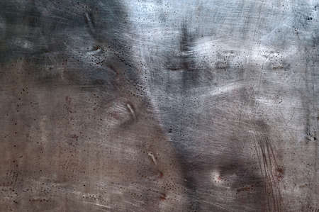 Background - an old patch from stainless steelの写真素材