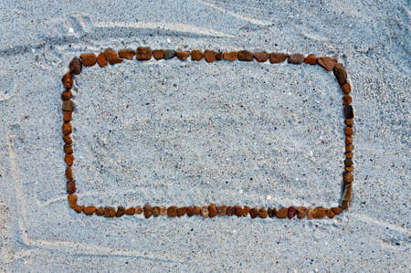 Abstract beach background - stone frame on the sand.の写真素材