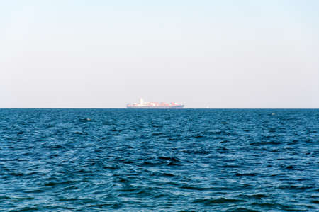 The Loaded Container Carrier far on horizon.の写真素材