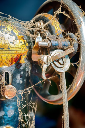 Retro Sewing Machine - fragment of old distressed sewing machine in dust. Closeup. Hdr image.
