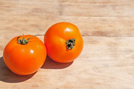Ripe Yellow Tomatoes on a wooden table. Closeup.の写真素材