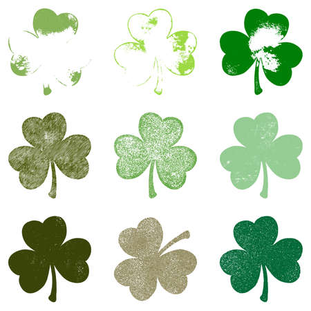 Set of Clover leaf in grunge style isolated on a white background. Distressed Patrick Day shamrock design element collection. Trefoil cutout shabby grainy template.のイラスト素材