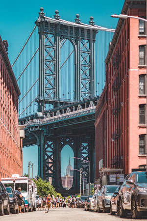 Manhattan bridge seen from a narrow alley enclosed by two brick buildingsのeditorial素材