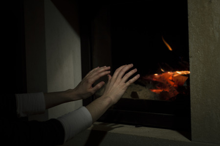 warm your hands next to the fireの写真素材