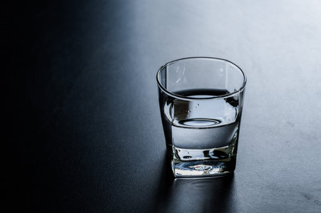 Glass of water on black background.