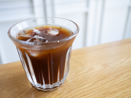 americano coffee beverage black cold drink ice glass cup fresh caffeine cafe espresso and water refreshment morning breakfast food relax lifestyle on wooden table brown background selected focusの写真素材