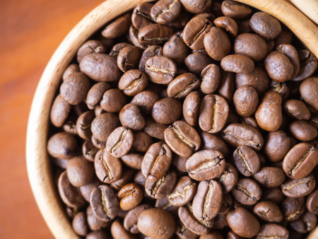 brown arabica coffee bean roast level medium taste delicate lively bright seed caffeine espresso drink food cafe beverage Chiang Rai, Thailand coffee on wooden table background top view selected focusの写真素材